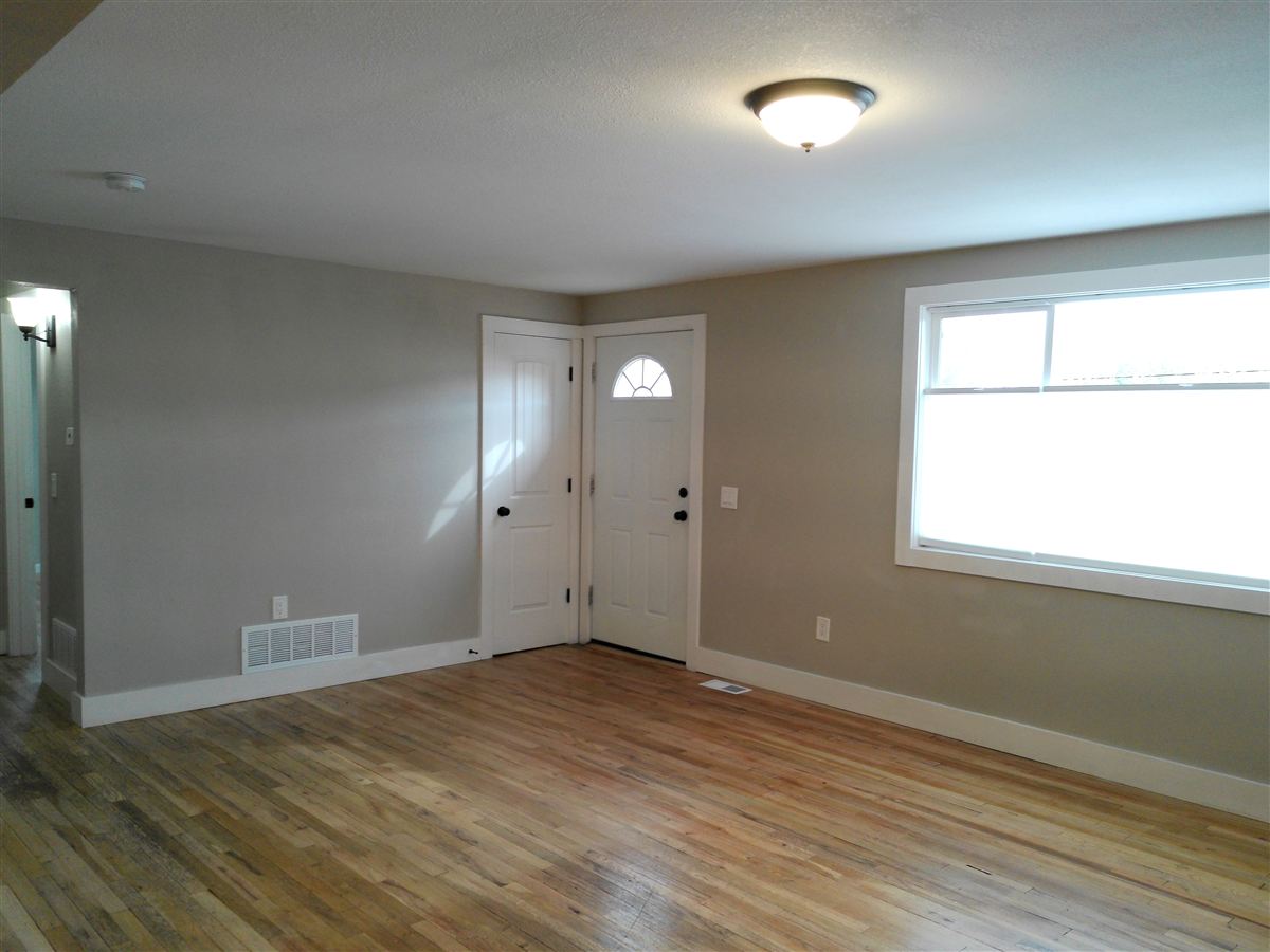 Living room with hardwood floors and front door