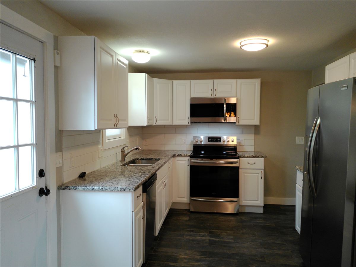 Kitchen with white cabinets and stainless appliances