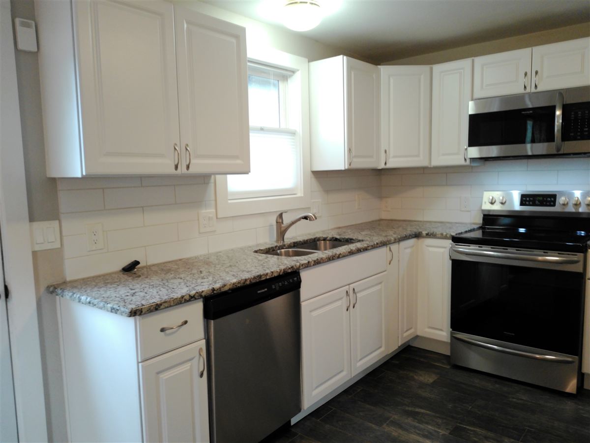 Kitchen with stone countertops and stainless range