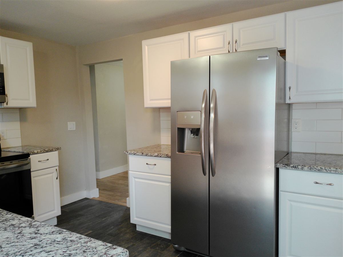 Kitchen with stainless refrigerator
