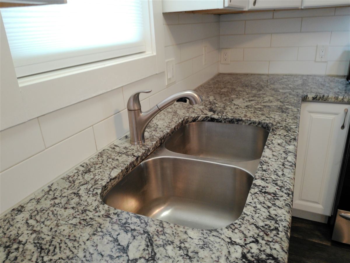 Double stainless sink with stone countertop