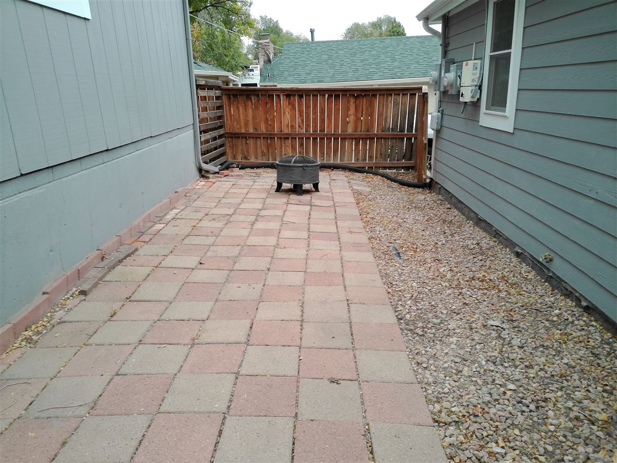 Paver patio along the side of the home